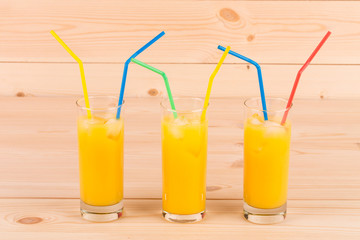 Orange juice on wooden table.