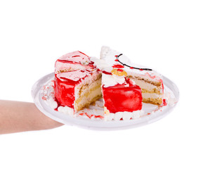 Hand holding tasty cake.