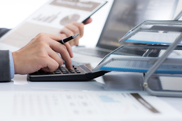 Fototapeta premium Businessman analyzing investment charts with laptop. Accounting