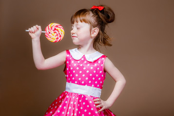 beautiful little girl with a lollipop