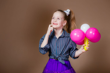 beautiful little girl with balloons in hands 