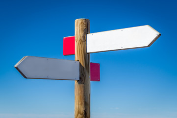 Wooden road sign with walking routes