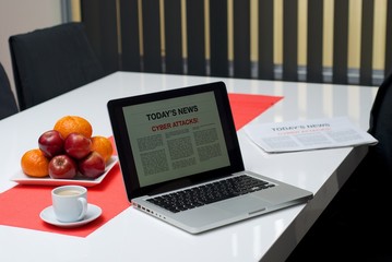 Cyber attacks article on a laptop screen