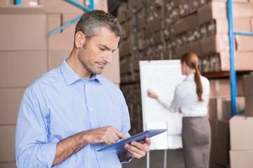 Fototapeta premium Warehouse manager working on tablet pc