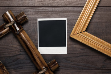 empty frames and old photo on wooden table