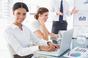 Businesswoman typing at a presentation