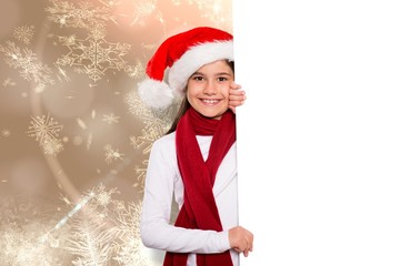 Composite image of festive little girl showing card