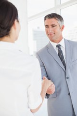 Businessman shaking co workers hand