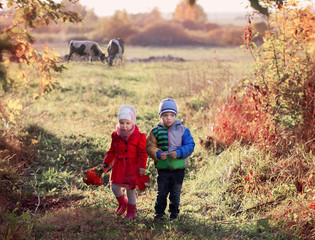 Naklejka na ściany i meble two children on autumn field
