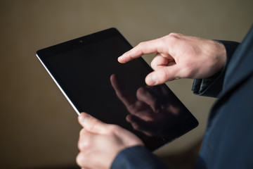 man holding digital tablet, closeup