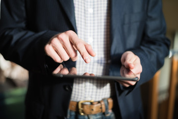 man holding digital tablet, closeup