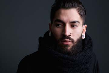 Fototapeta premium Modern young man with beard and piercings