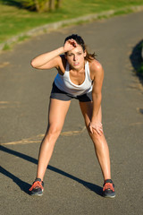 Tired female athlete taking a running break