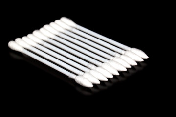 cotton buds on black background