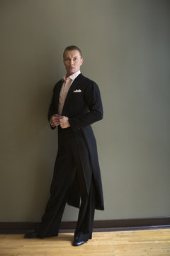 Dancer in dance studio. A man in a frock coat. 