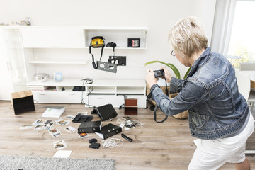 Woman photographing chaos after burglary when coming back in her one-family house