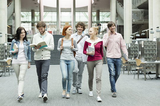 Group of students walking in a university library