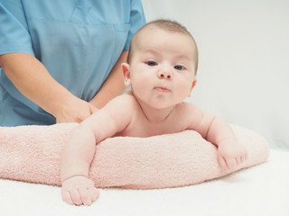 Doctor massage small caucasian baby