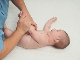 Doctor massage small caucasian baby