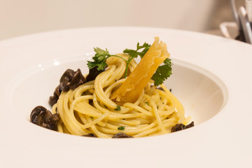 Spaghetti with snails and sauce in a dish