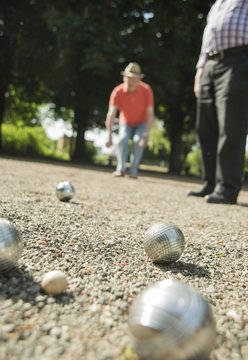 Two old friends playing boule in the park