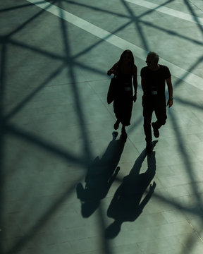 Silhouettes and shadows of people walking