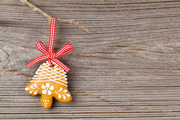 Gingerbread cookie hanging on wooden background. Christmas decor