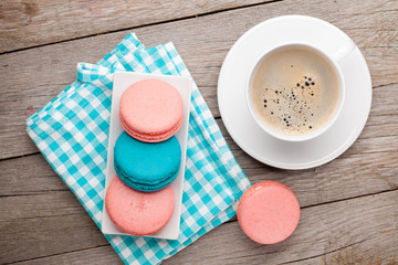 Colorful macaron cookies and cup of coffee