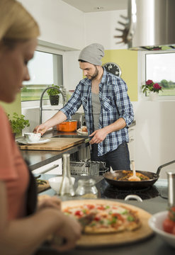 Couple cooking in kitchen at home