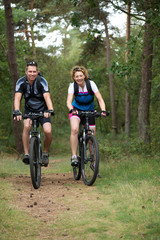 Fototapeta na wymiar Happy couple cycling in nature