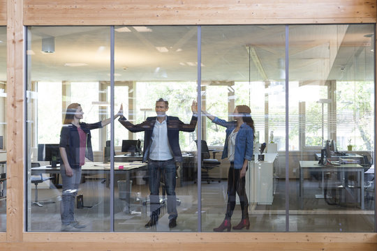 Team of three business people at workplace in modern office