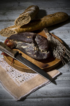 Smoked ham and onion baguette on wooden board