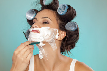 attractive young woman shaves her face