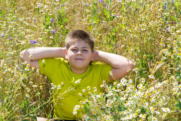 Boy in a field with flowers