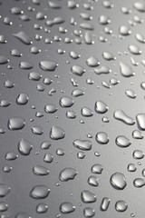 Raindrops on silver surface