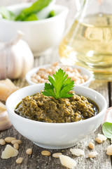 pesto sauce in a bowl, vertical