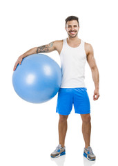 Athletic man with a pillates ball