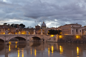 Sant 'Angelo Bridge and St. Peter's Basilica at dusk, Rome.