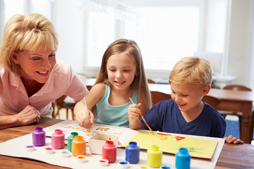 Fototapeta premium Grandmother Painting Picture With Grandchildren At Home