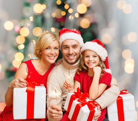 happy family in santa helper hats with gift boxes