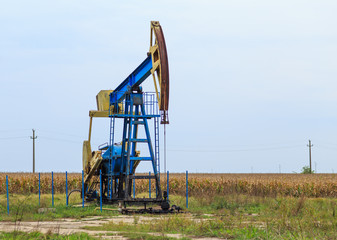 Fototapeta na wymiar Active oil and gas pump in remote rural area