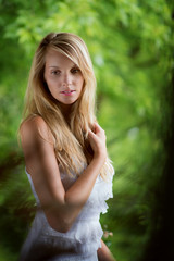 beautiful girl with blond hair at green background