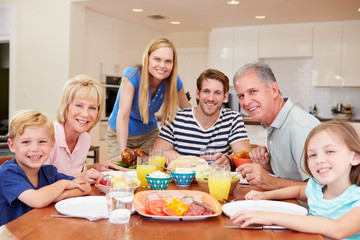 Obraz na płótnie Canvas Multi Generation Family Enjoying Meal At Home Together