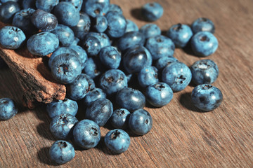 Tasty ripe blueberries, on wooden background