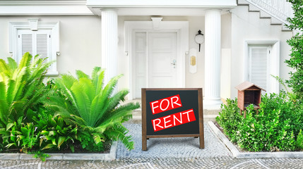 Fototapeta premium Real estate sign in front of new house for rent