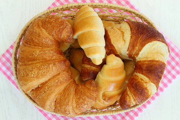 Selection of butter croissants in bread basket