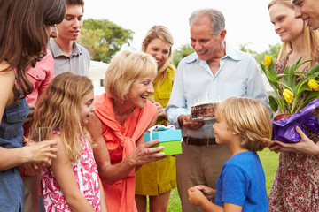 Multi Generation Family Celebrating Birthday In Garden