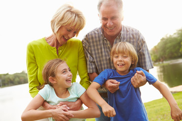 Grandparents Playing With Grandchildren Outdoors