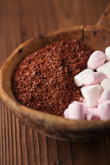 fine grated chocolate and marshmallow candy  in old spoon, woode