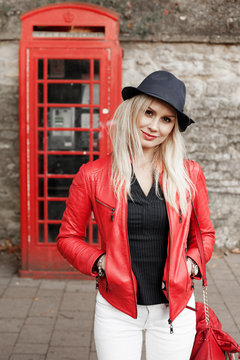 Attractive trendy young woman in a red jacket